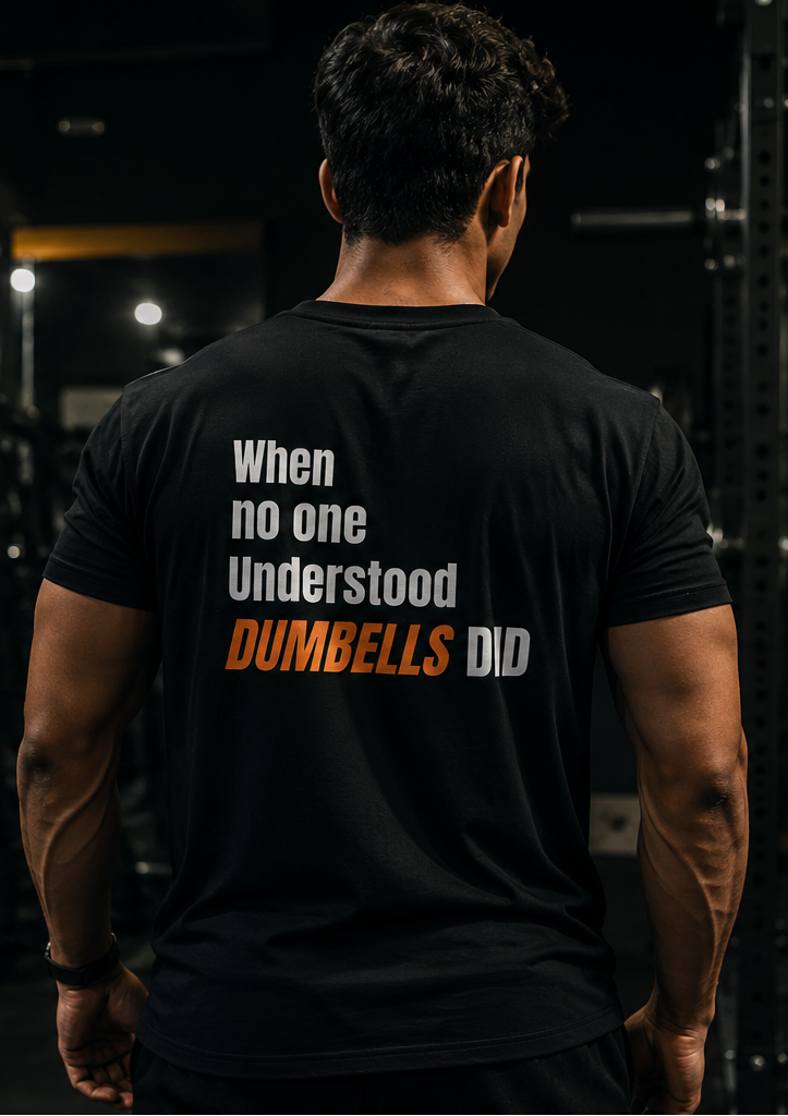Man wearing a black t-shirt for gym with 'Understood' text in a dark setting