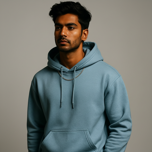 Man wearing a light blue hoodie against a dark background